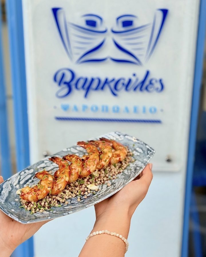 Grilled shrimp in front of the Varkoules sign